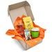 An example of a corrugated gift box with example products, box unbranded and orange tissue gift-box filler.