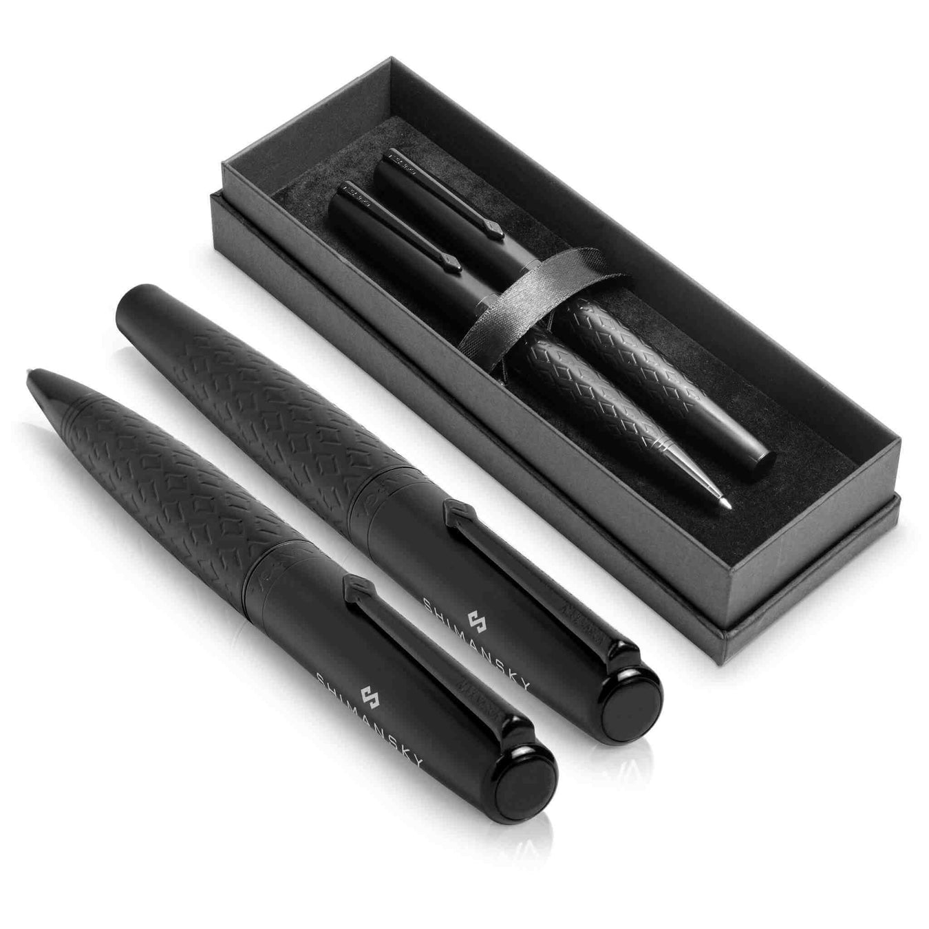 A set of luxury metal pens in formal black presented both in a box and outside the packaging