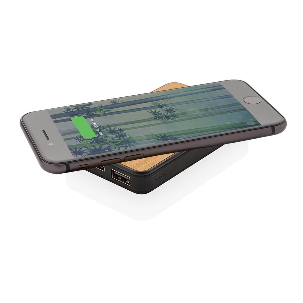 Bamboo Anti-microbial Wireless Powerbank Charging a mobile phone