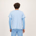 Male model showing the back of a baby blue floral scrub top