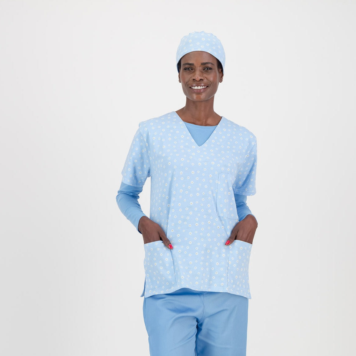 Female model wearing a baby blue floral scrub top