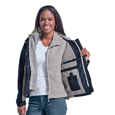 Smiling front-facing attractive female model showing different jacket layers by holding one side of the jacket open