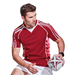 Rugby player in action with a rugby ball and wearing a red rugby shirt.
