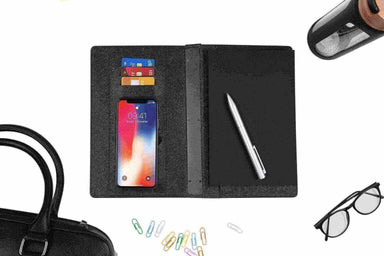 Wireless power bank and notebook shown with other corporate branded goods